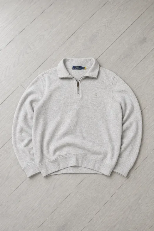 After: the same quarter zip as an AI studio flat lay on a light wooden floor